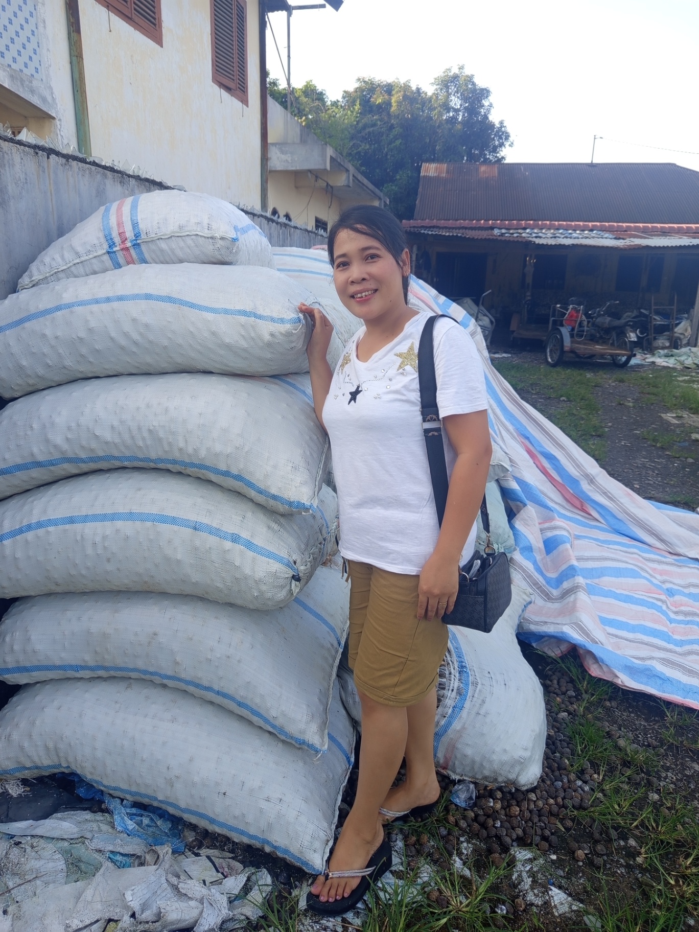 Loading candlenut sacks into an export container in Indonesia
